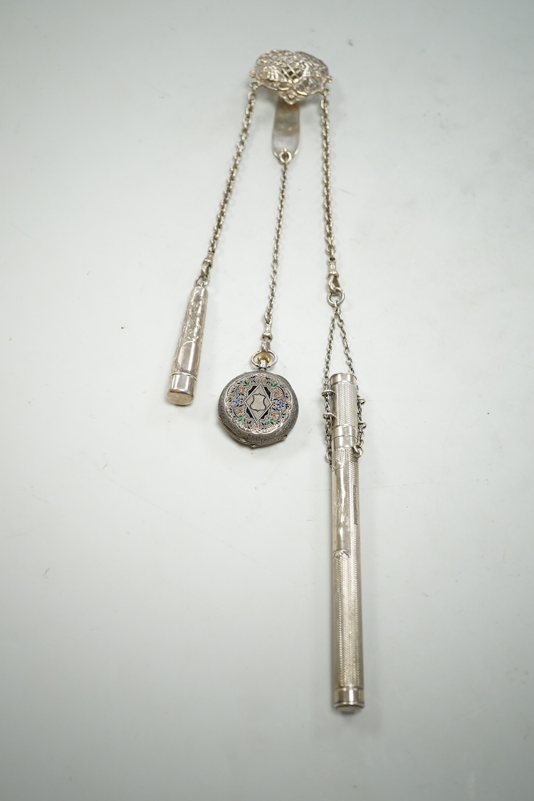 An Edwardian pierced silver chatelaine, by Samuel Jacob, London, 1902, with three accoutrements to include two silver cases and a enamelled fob watch, overall length 34cm.